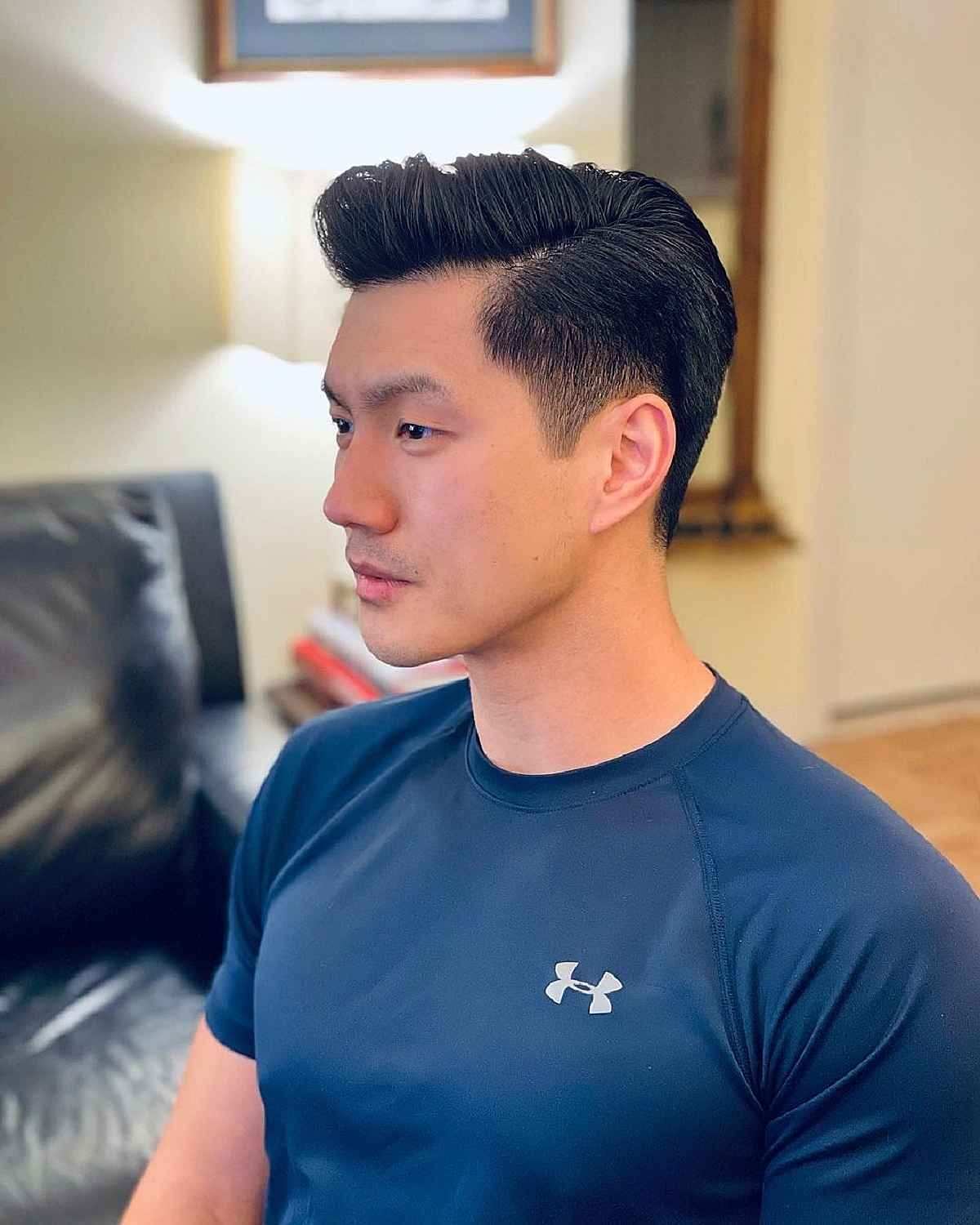 A clean, polished classic men's quiff hairstyle with shorter sides.