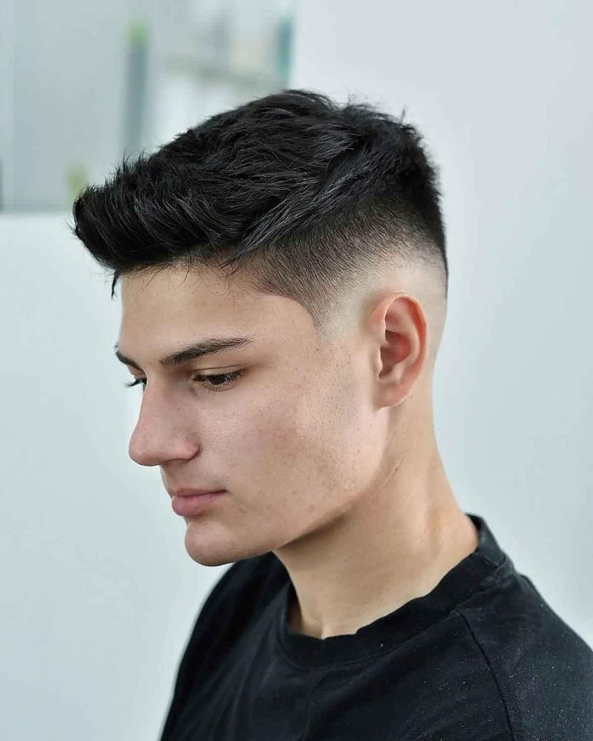 A subtle, professional quiff hairstyle with a low taper fade.