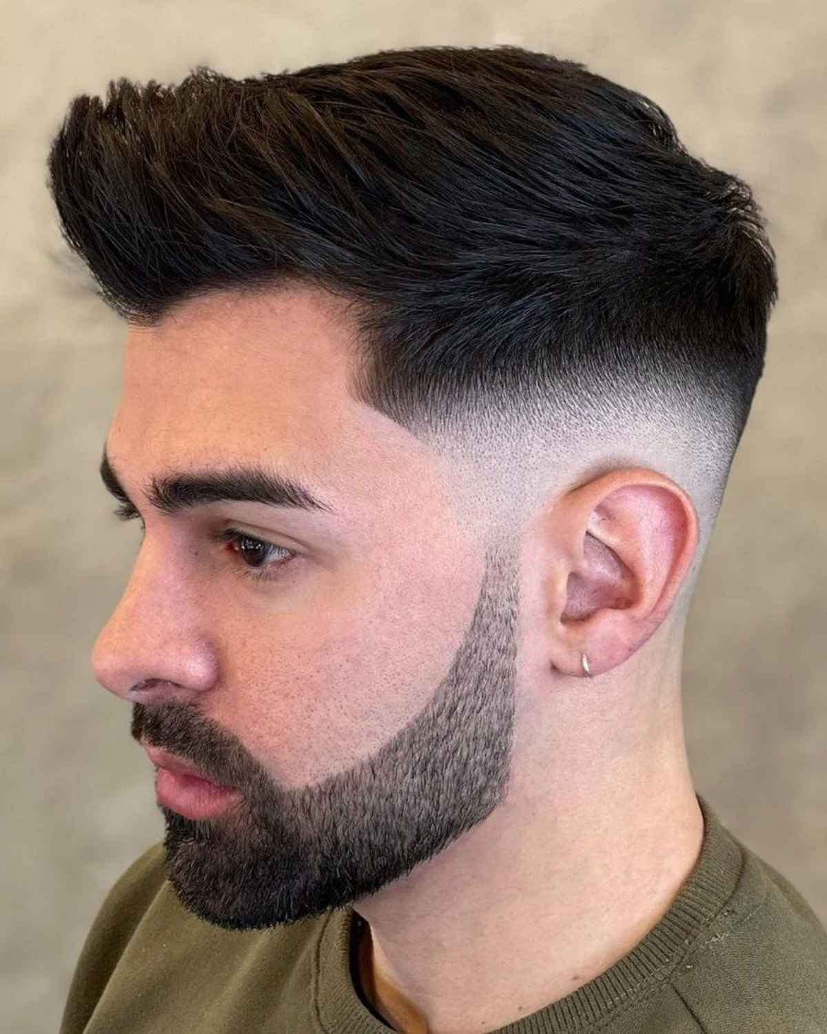 A balanced, versatile quiff haircut with a smooth mid fade.