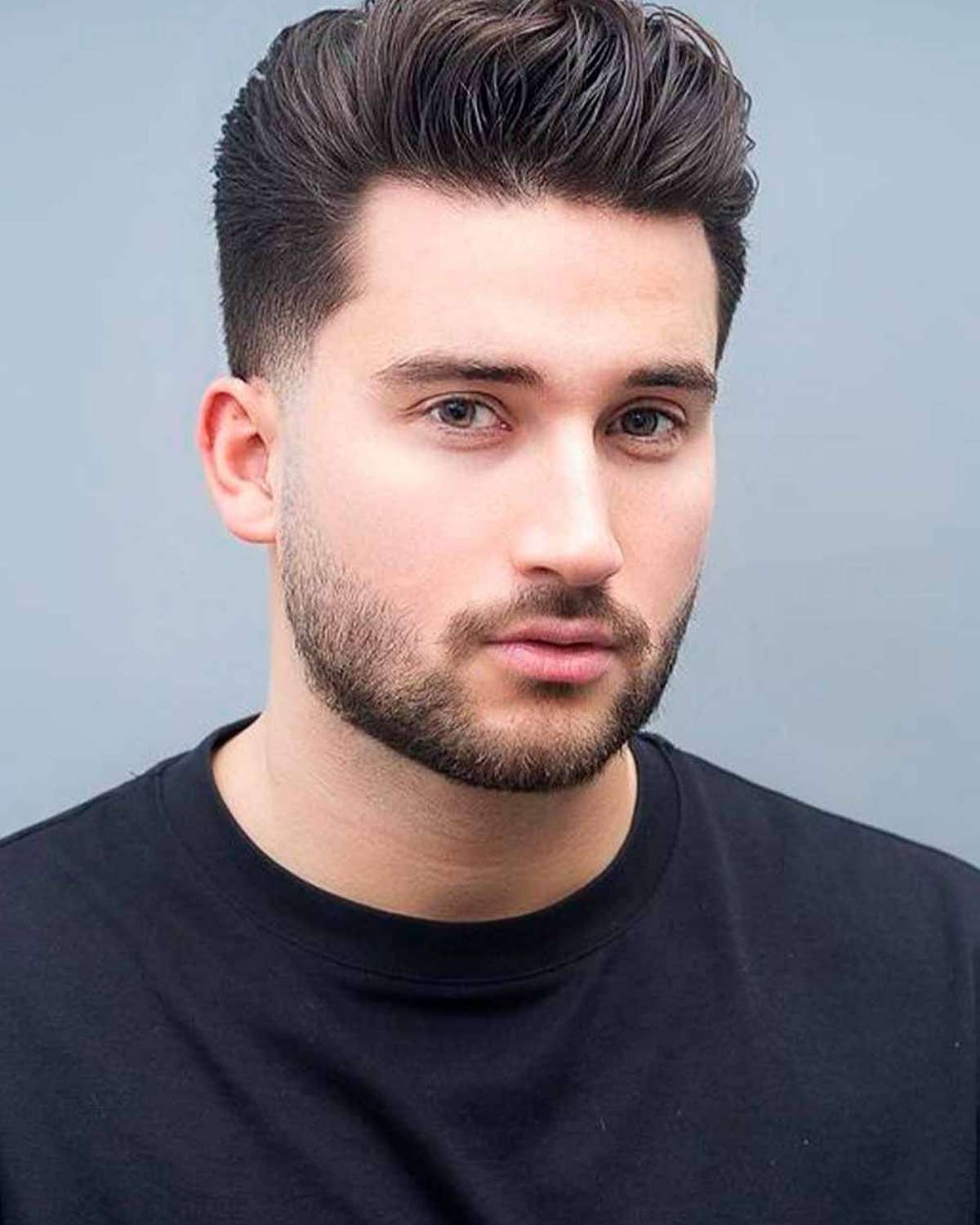 A soft transition quiff haircut with a seamless taper fade.