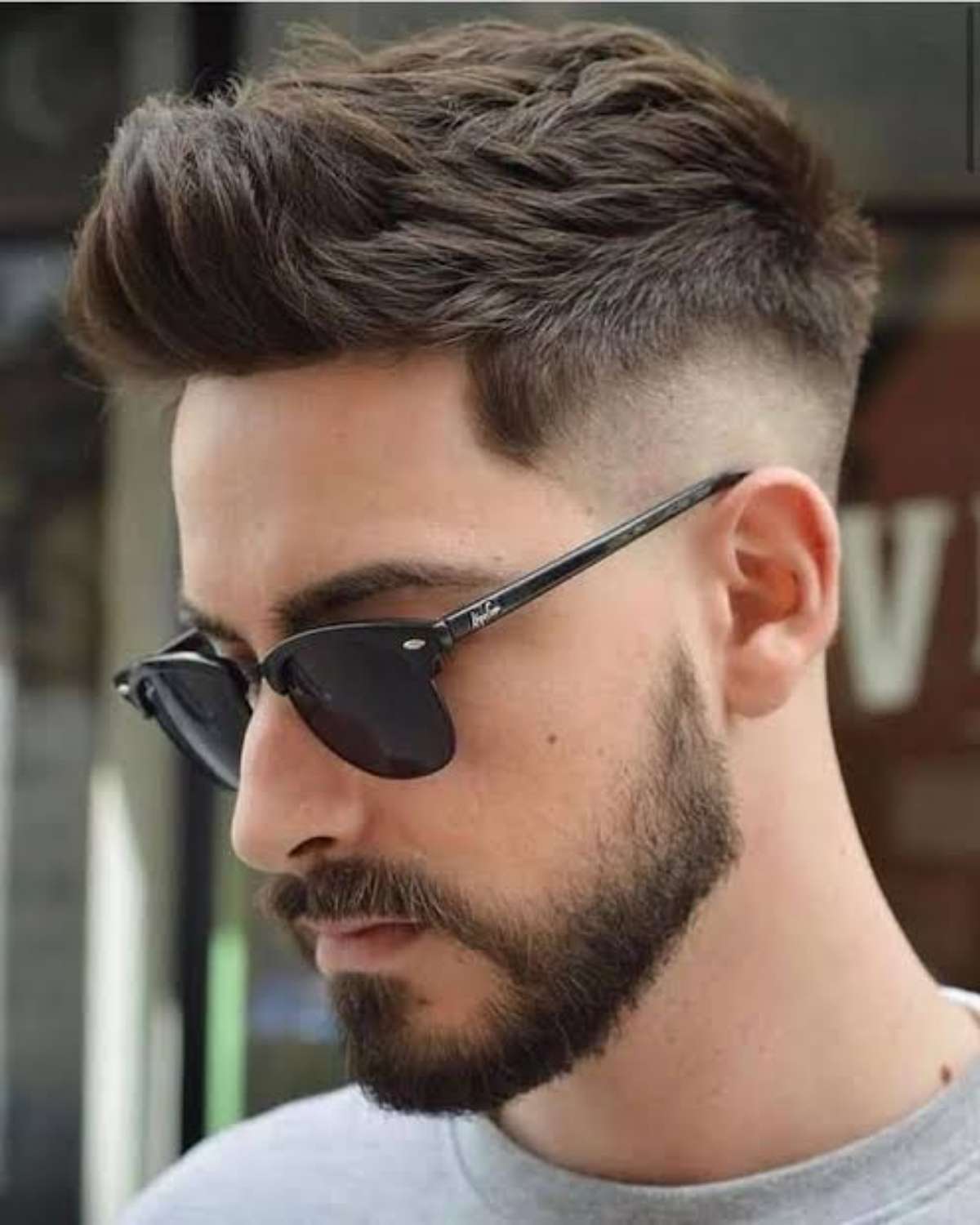 A stylish quiff with a dynamic drop fade around the ear.