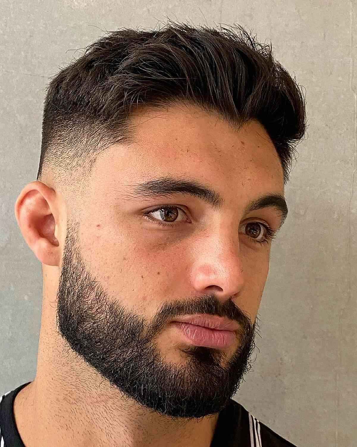A stylish voluminous quiff paired with a well-groomed beard.