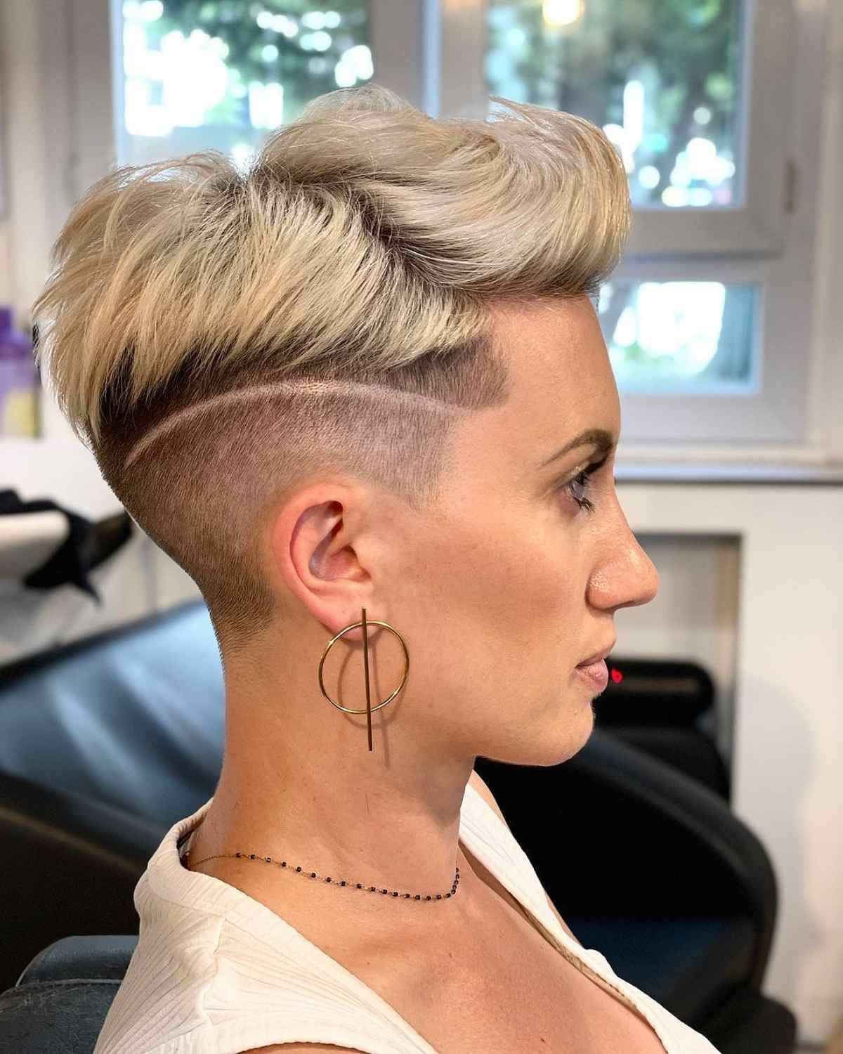 An edgy disconnected undercut hairstyle with a quiff top.