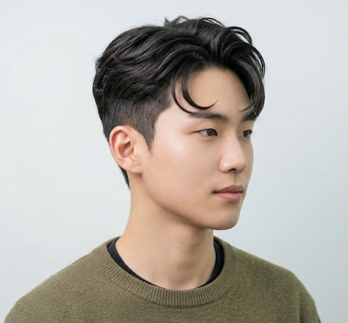 Two block haircut with comma-shaped fringe curving softly over the forehead