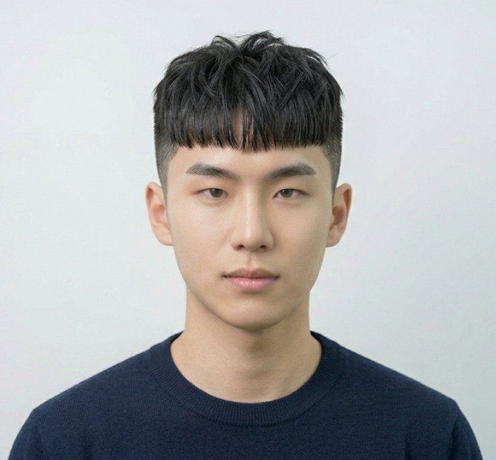 French crop two block haircut with blunt fringe and tight tapered sides