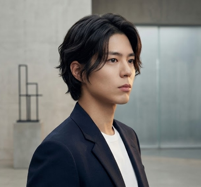 Korean wolf cut hairstyle featuring layered texture, soft movement, and tousled styling for youthful men