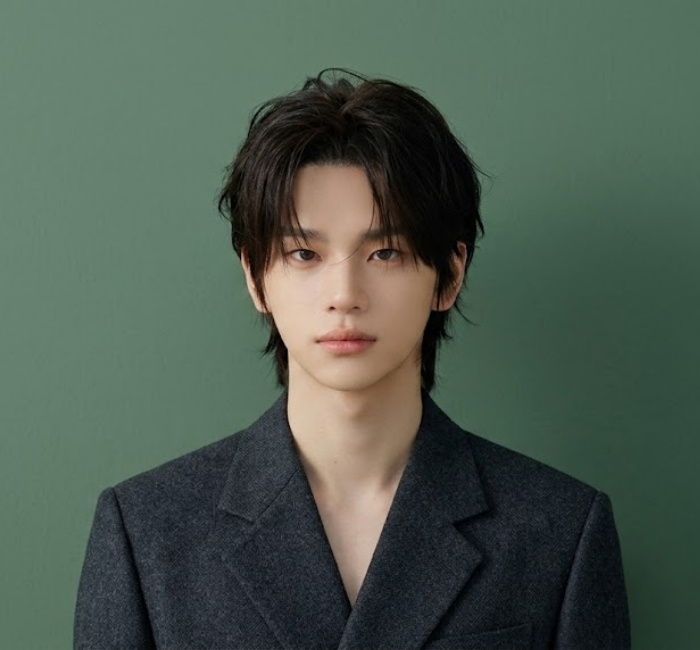 Korean curtain haircut with center part, long flowy layers framing face, and tapered sides for refined look