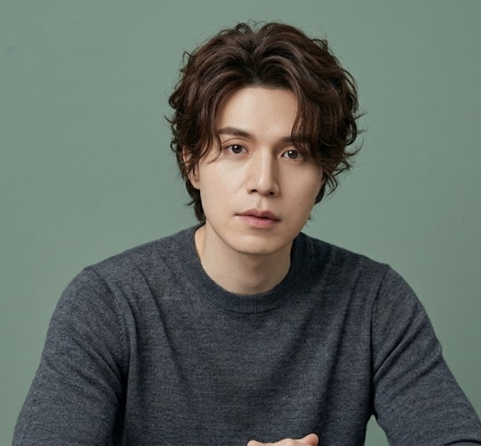 Korean surfer cut with tousled waves, light texture, beach-inspired flow, and layered movement for men