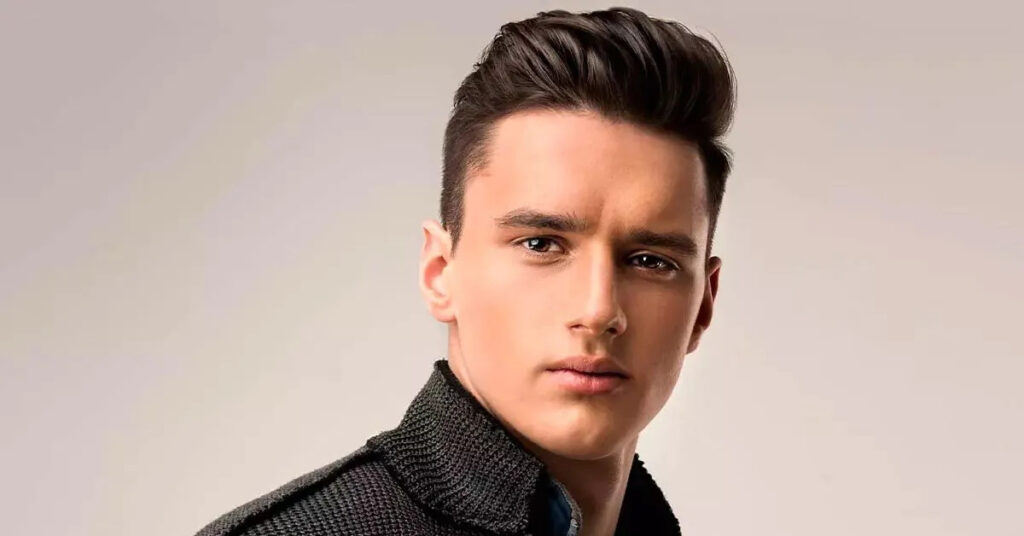 A stylish man with a modern textured quiff haircut and a skin fade, showcasing height and volume.