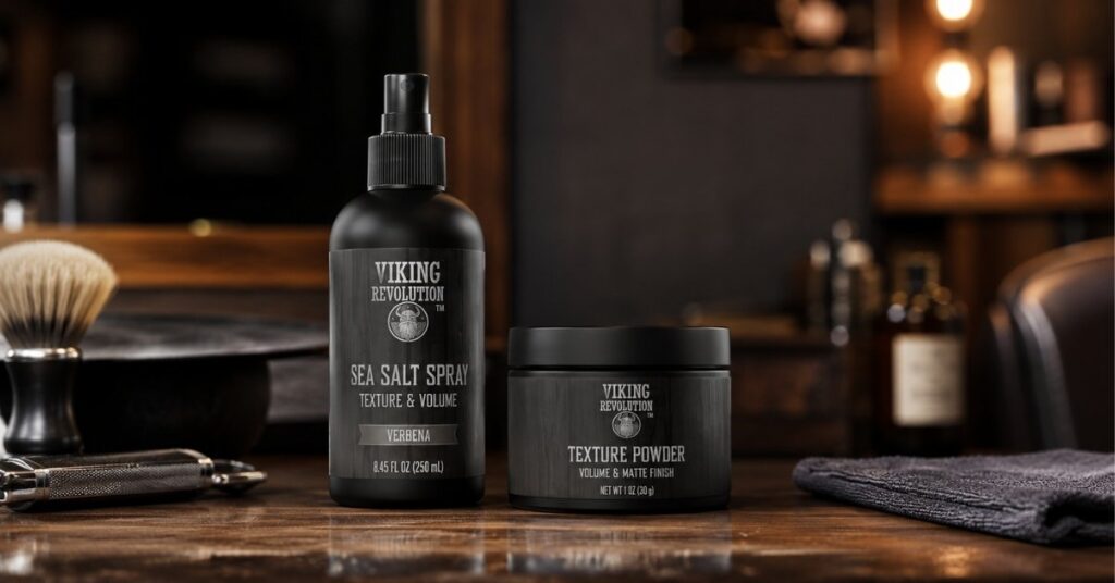 Sea salt spray bottle and texture powder jar on a wooden barber shop table.