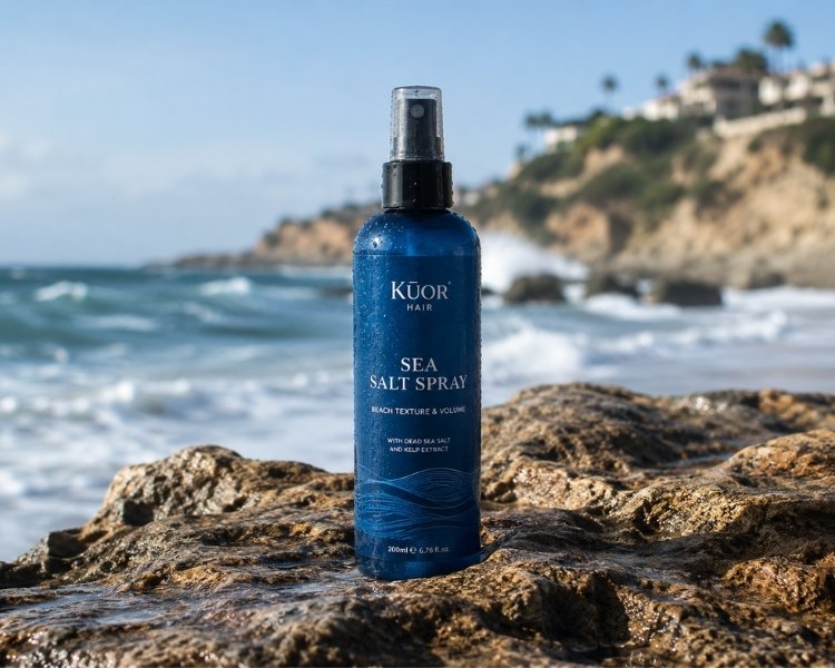 Sea salt spray bottle on coastal rocks with ocean waves in the background.