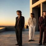Four men showcasing different mullet hairstyles including modern fade and curly mullet styles